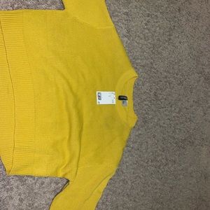 a yellow cropped sweater